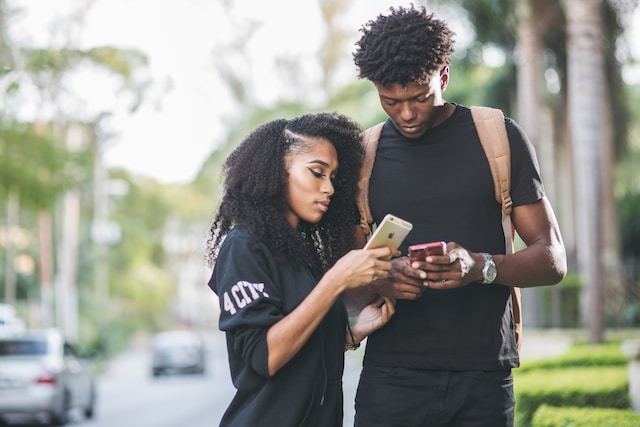 two people outside sharing a text fundraising campaign