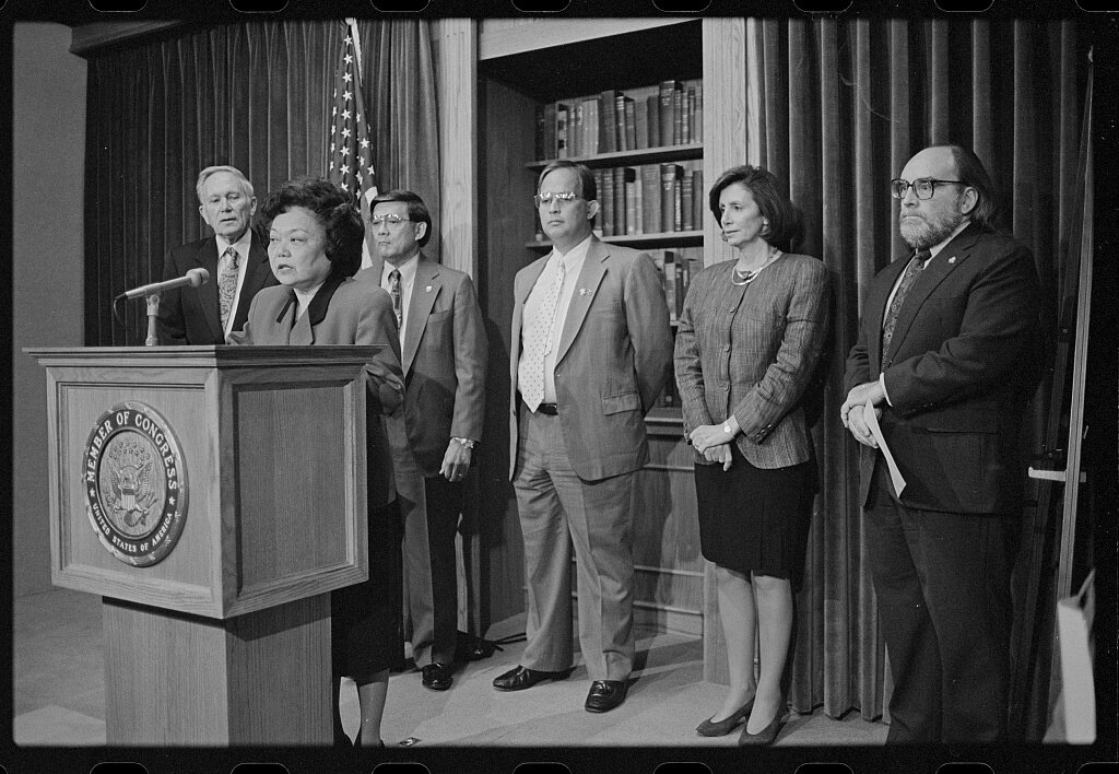 Representative Patsy Mink announces the formation of the Congressional Asian Pacific American Caucus at a press conference with (left to right) Representatives Don Edwards and Norman Mineta, Guam Delegate Robert Underwood, and Representatives Nancy Pelosi and Neil Abercrombie