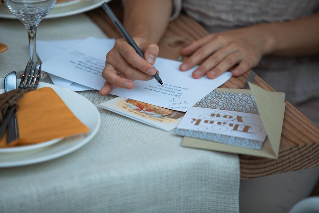 someone wriitng donation thank you notes for giving tuesday strategy